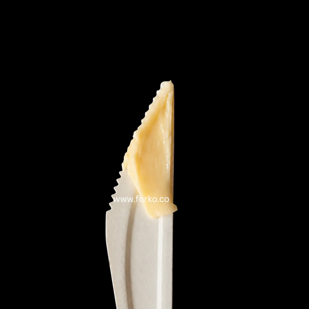 Serrated paper knife cutting through food